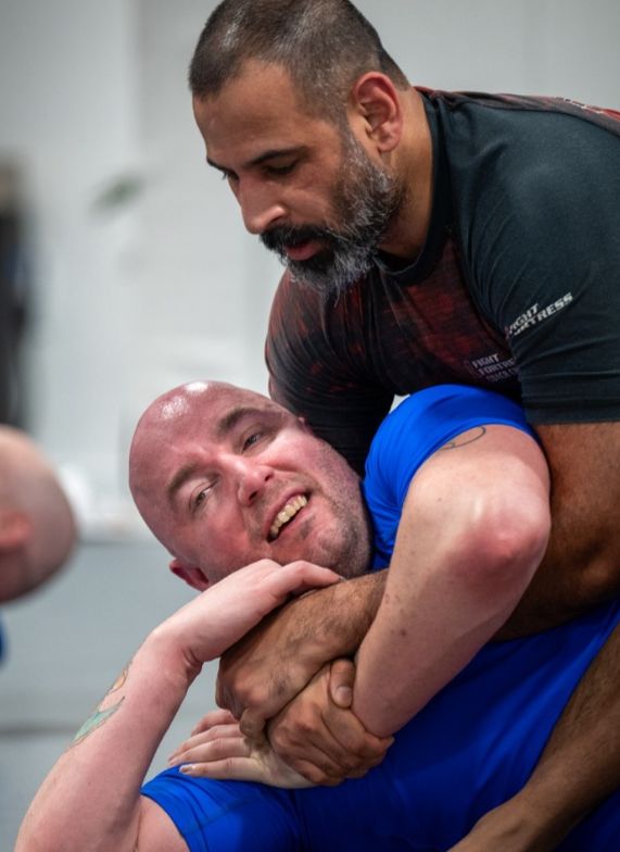 BJJ instructor coaching student