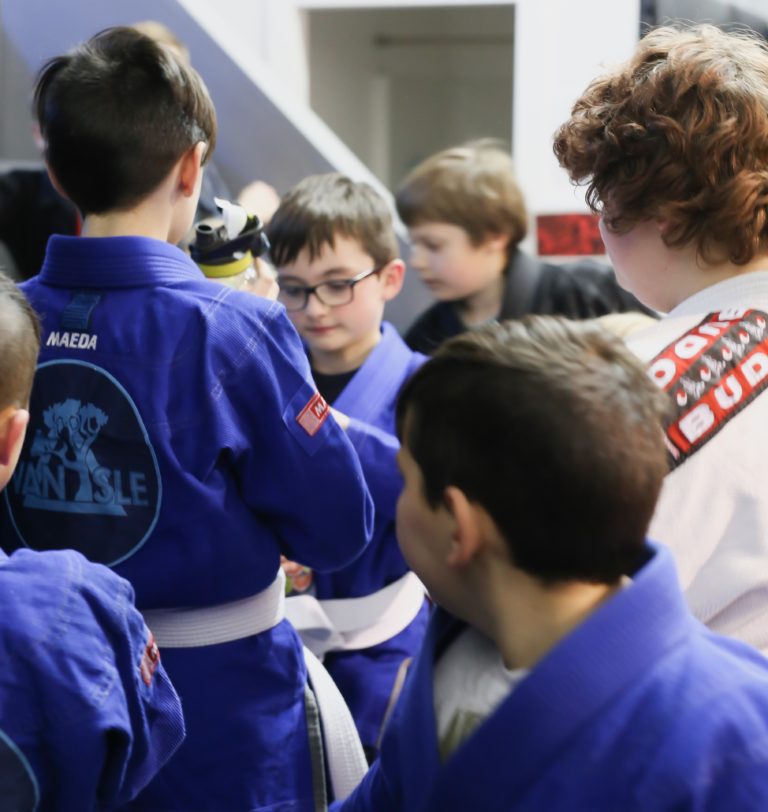 Young Van Isle BJJ students in blue gis preparing for class